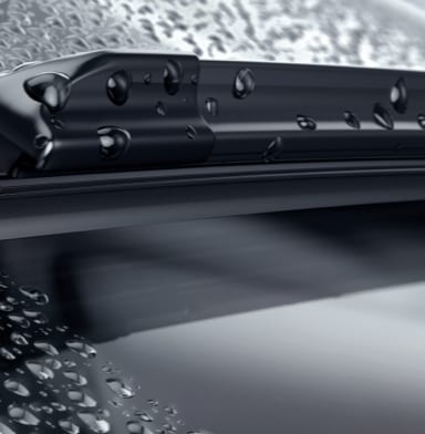 Close-up of windshield wiper blades on a rainy day