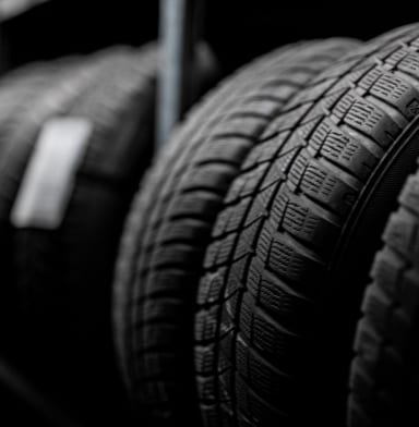 Black and white image of shelves of tires in a shop