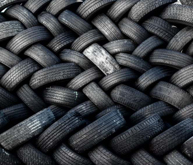Overhead view of many tires piled in a woven style