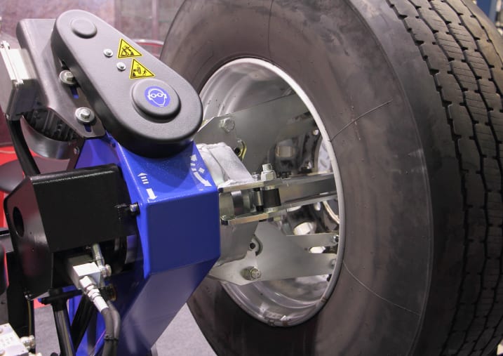 Close-up of a commercial tire being installed and rotated in a shop