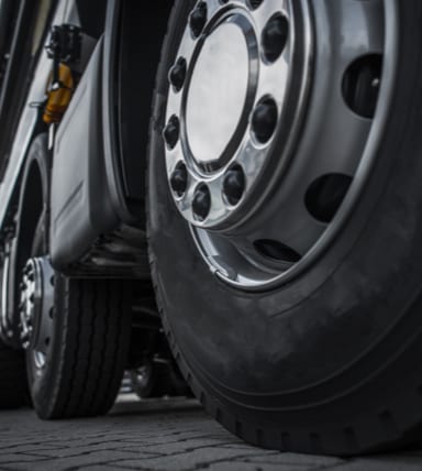 Close-up of large truck tires parked in a garage