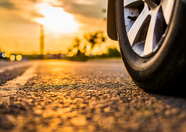 Performance tires on concrete road at sunrise